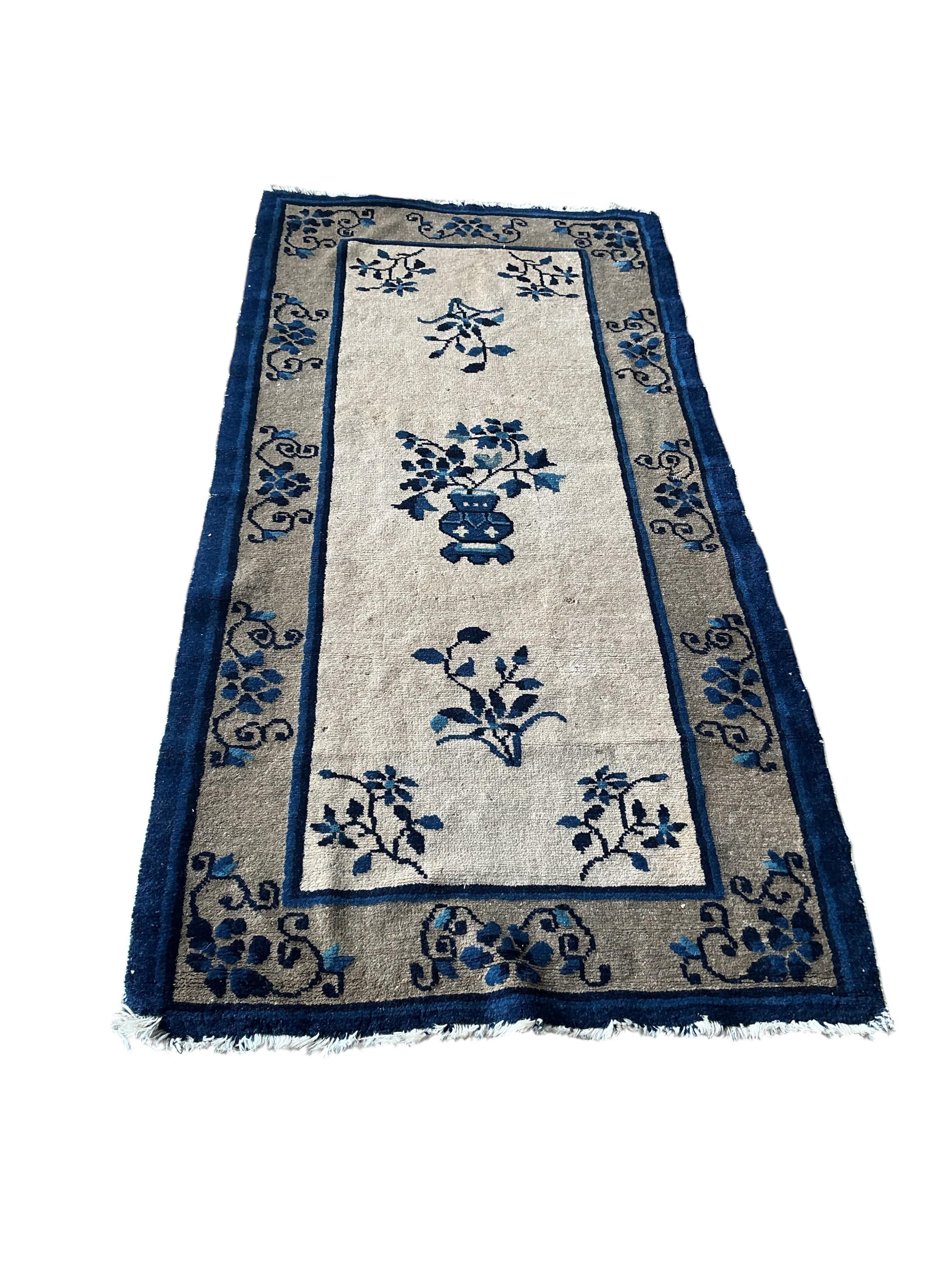 A Chinese fawn ground floral rug, 160 x 78cm